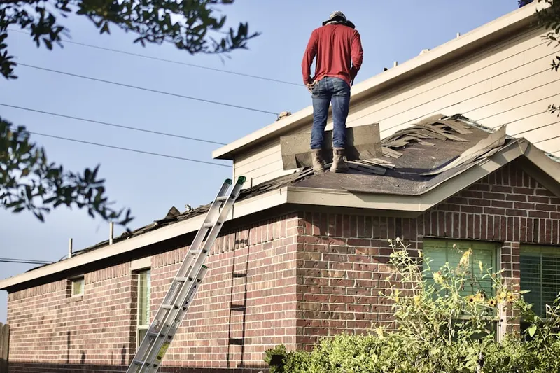 Professional roofer working on a residential roof in Mabton